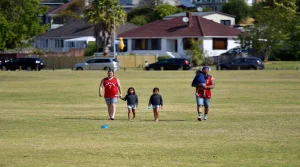 Family enjoying a simple repeated outing together in a park or neighborhood setting