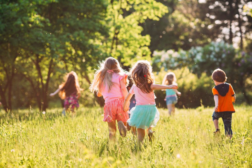 Children enjoying active outdoor play in a field