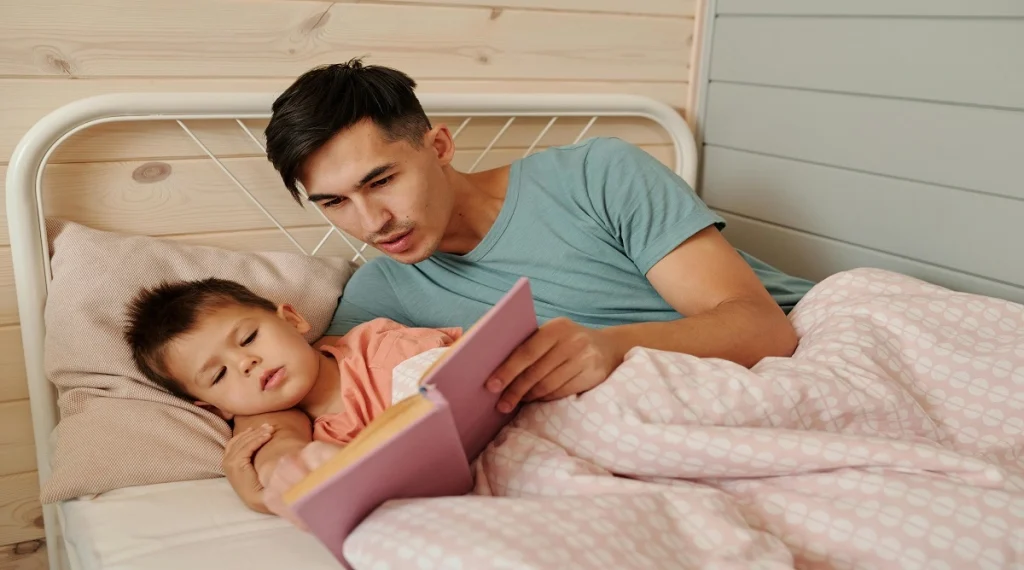 Parent reading with a child during a calm wind-down period before bed