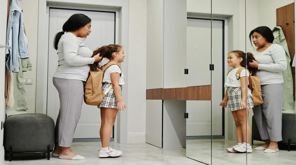 Child getting ready for school with organized morning items nearby