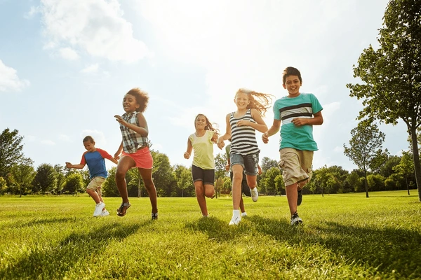 Children playing together outdoors on grass