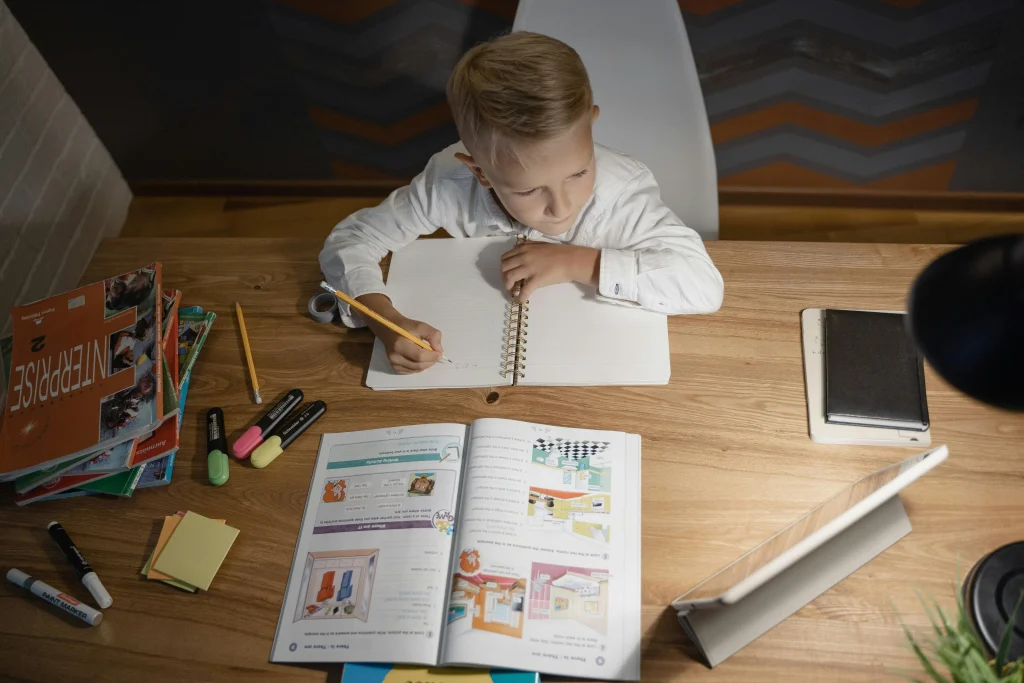 Organized familiar home learning place with school materials stored simply