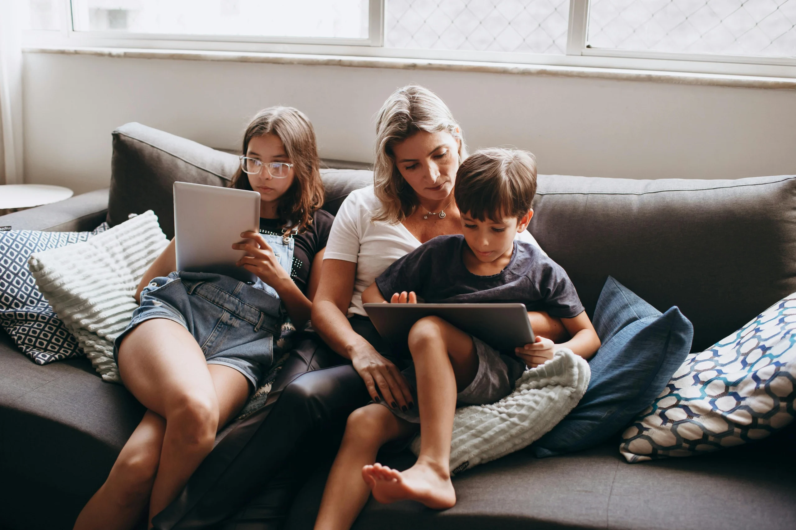 Parent putting a tablet away in a shared family space to support screen limits