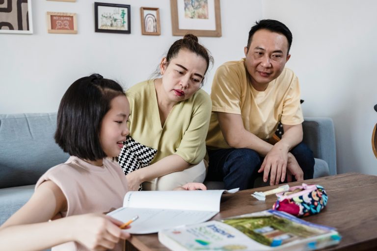 Parents supporting child in a home learning environment
