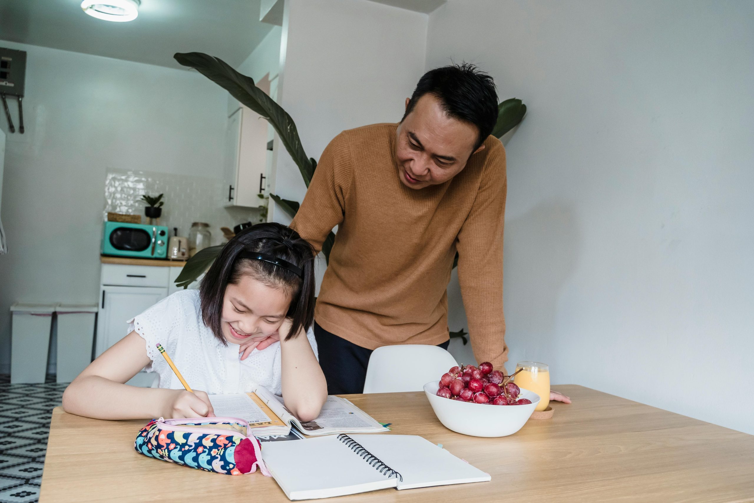Parent supporting a child during a calm homework routine at home