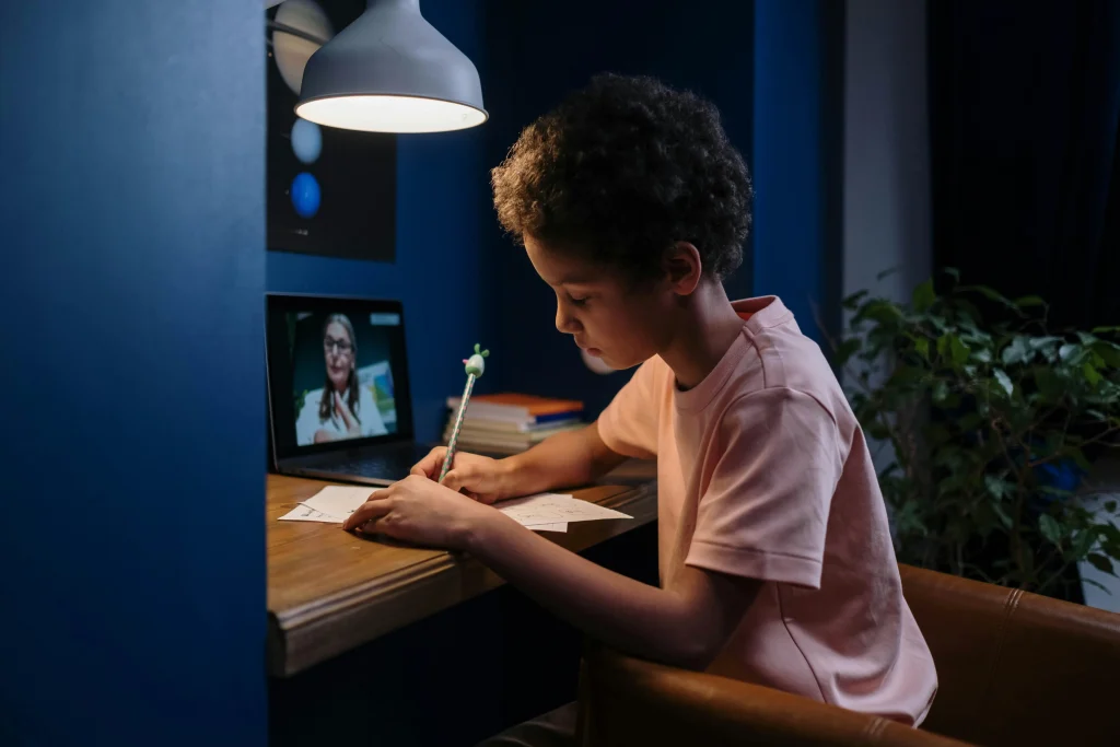 Child finishing homework before a predictable screen time routine at home