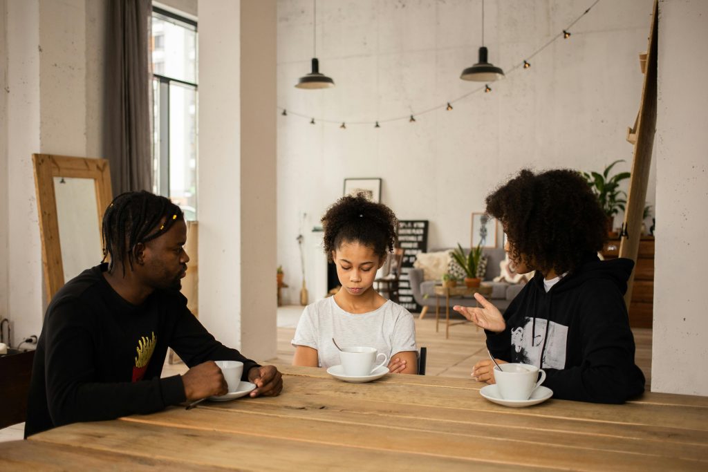 Child eagerly speaking during a family conversation at home