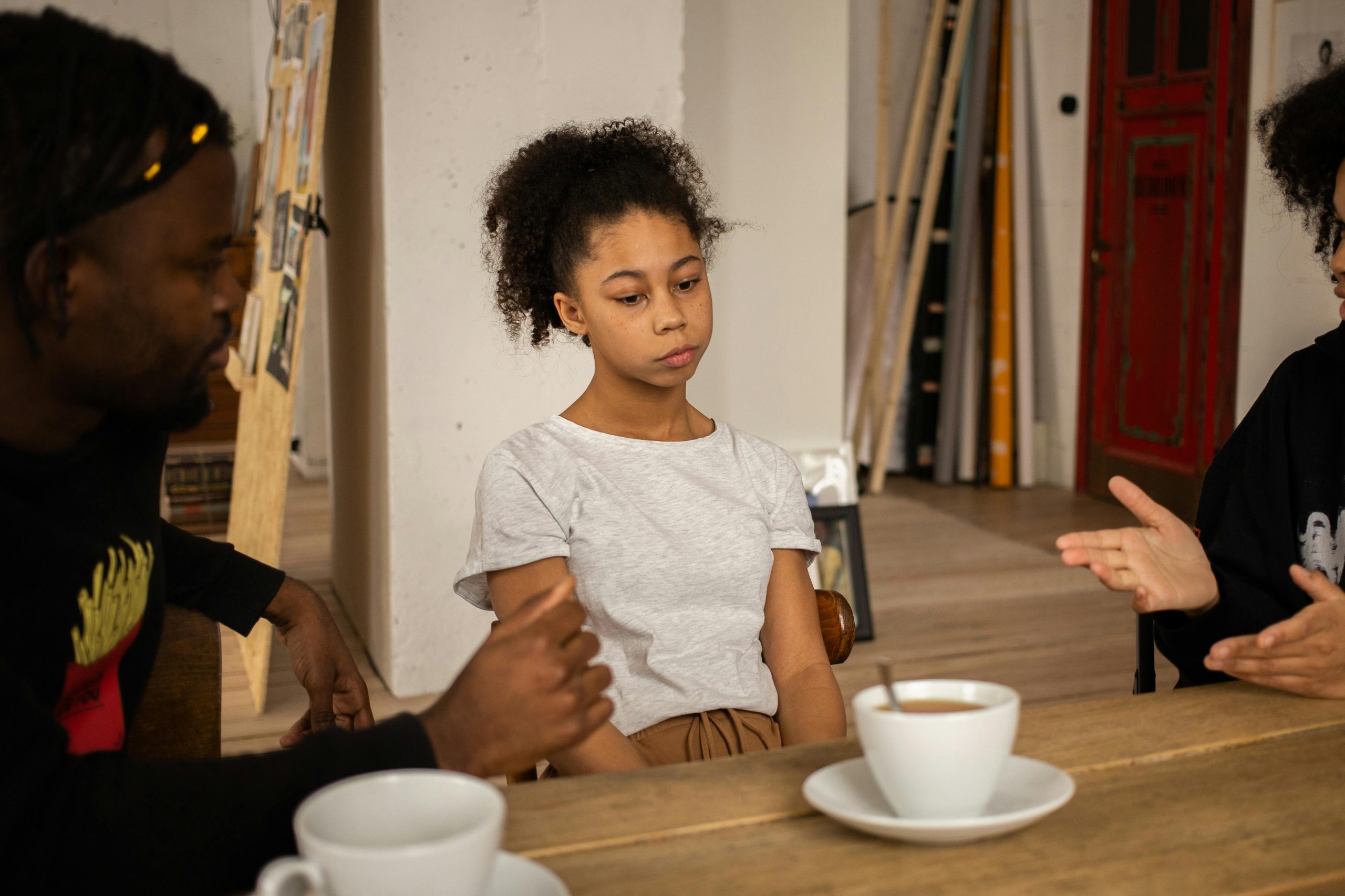 Parent helping children talk through a disagreement about fairness