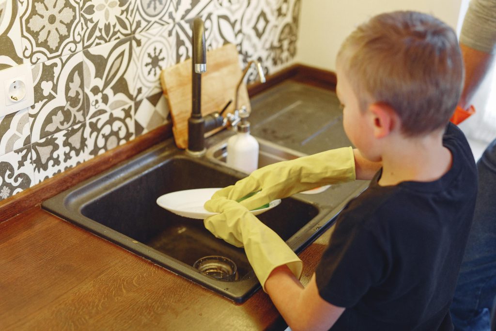 Child completing a visible daily routine task independently at home