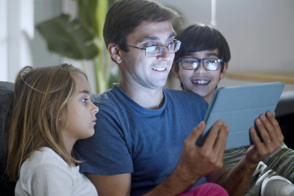 Parent supervising child using a tablet at home