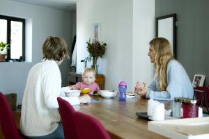 Parent speaking calmly to a child during a home conversation