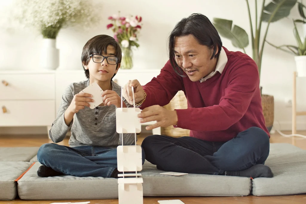 Parent calmly encouraging a child through a manageable challenge at home