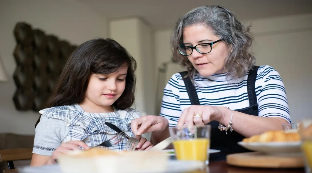 Parent calmly guiding a child through a consistent daily routine at home