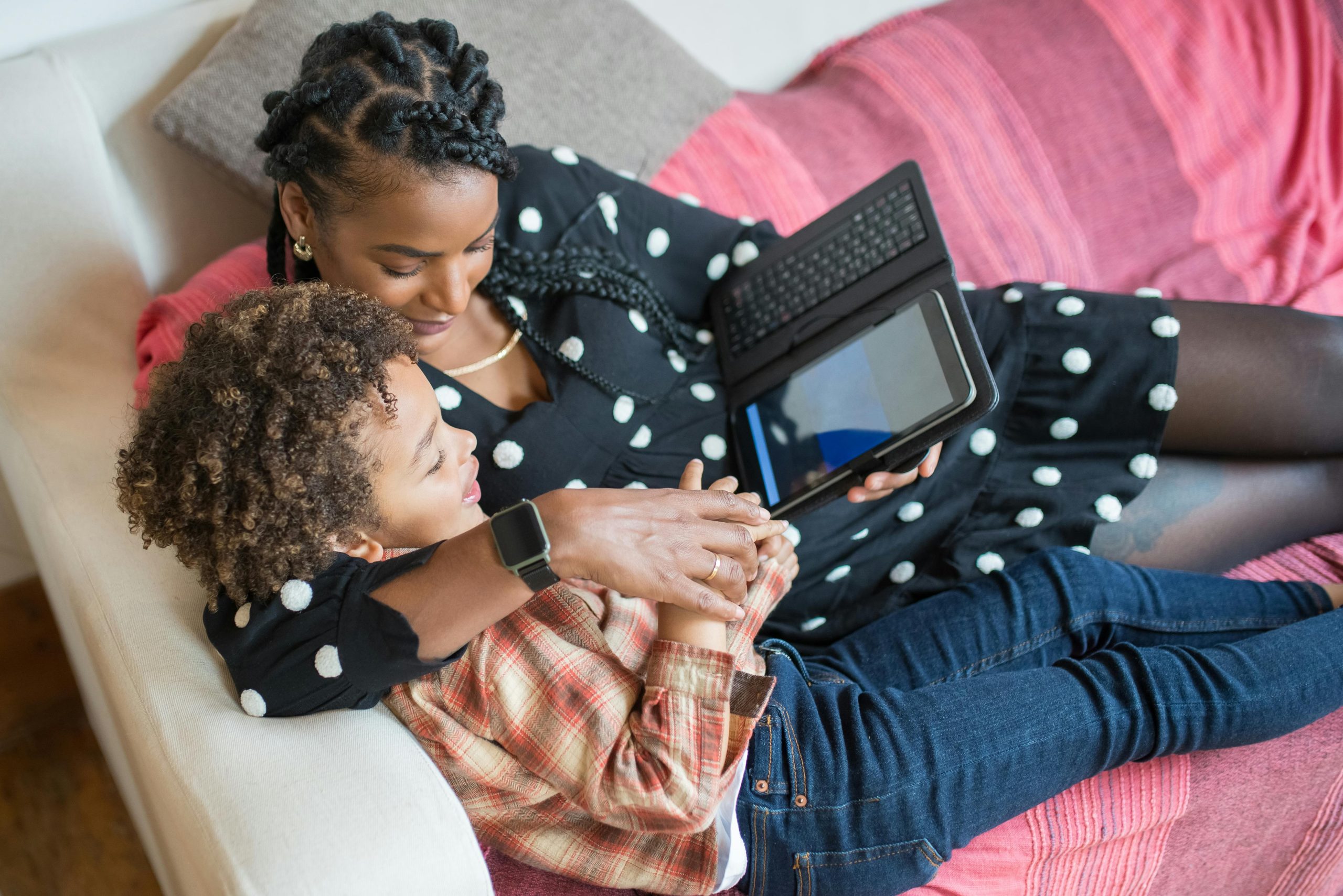 Child using a tablet while a parent prepares for a transition away from screens