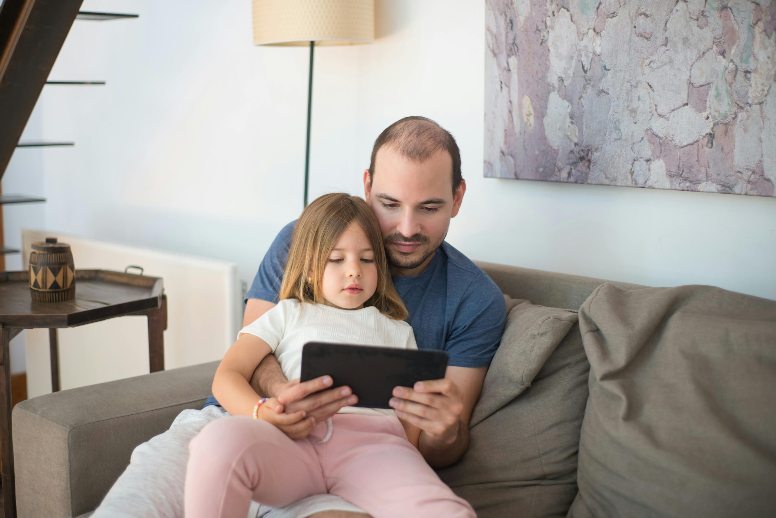 Child asking for a tablet in a family living room