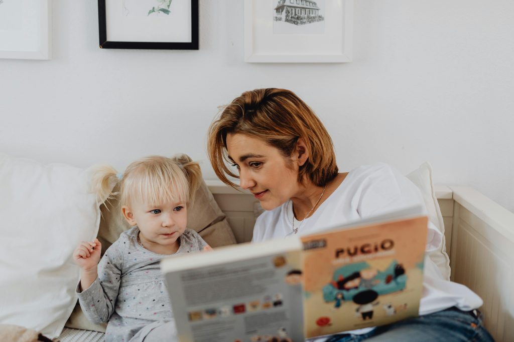 Parent and child looking at books together