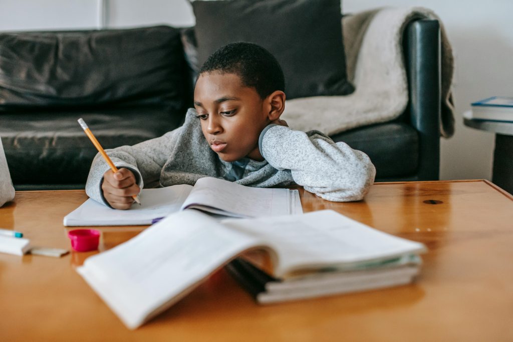 Child following a simple learning task at a table with organized materials