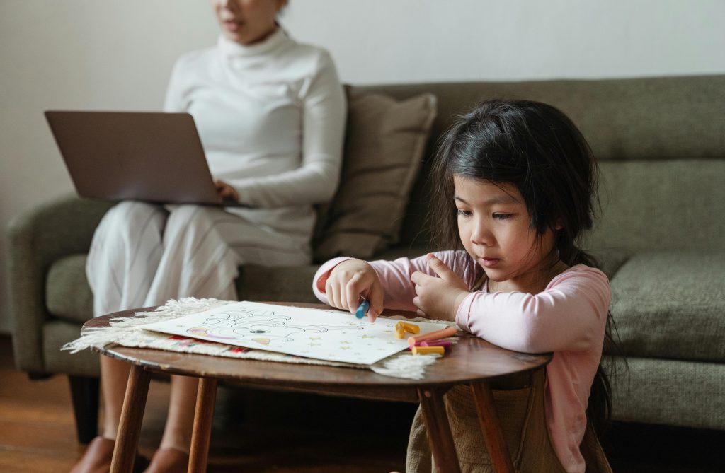 Child transitioning from a screen to a drawing activity at home
