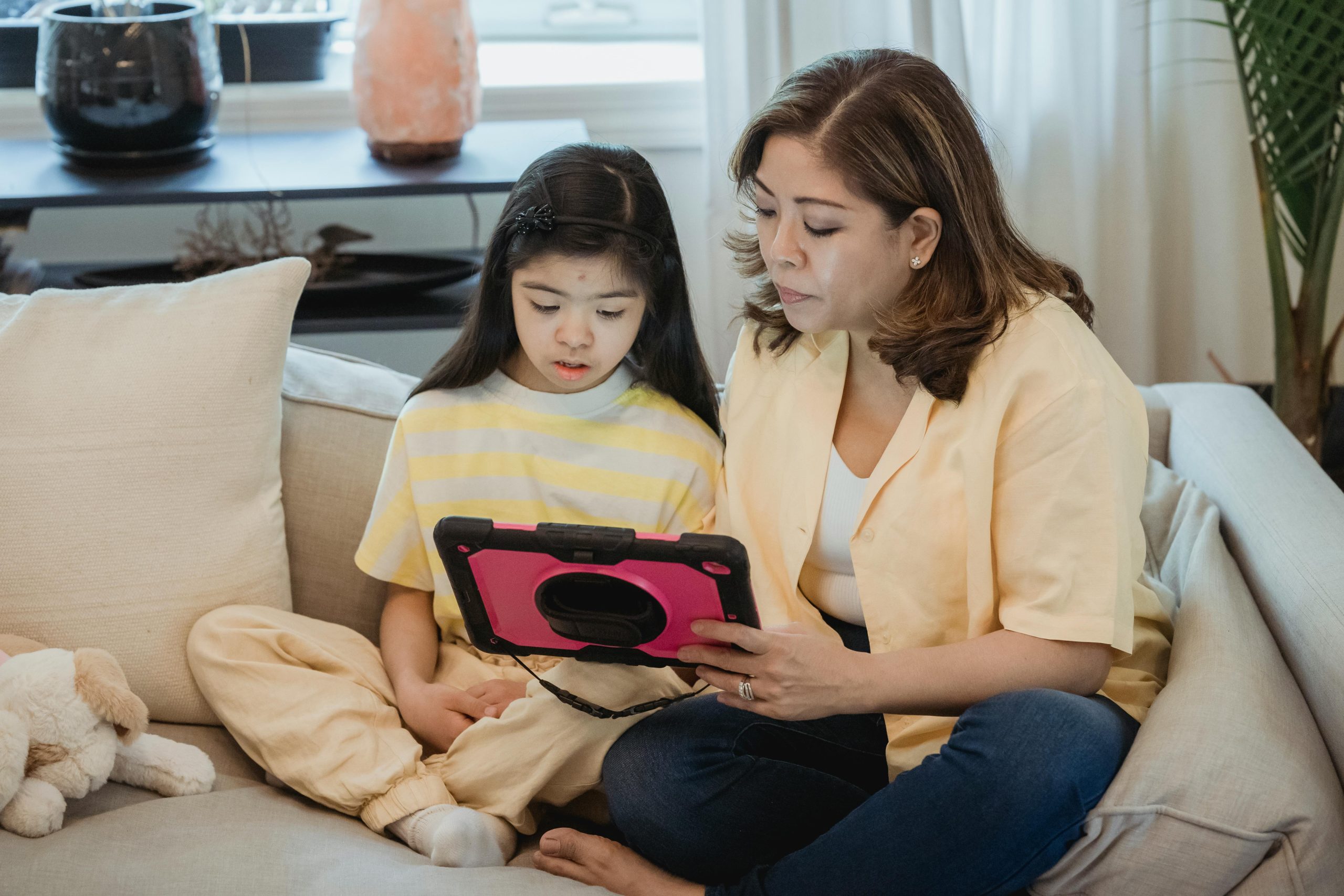 Parent and child using a tablet together in a supervised setting
