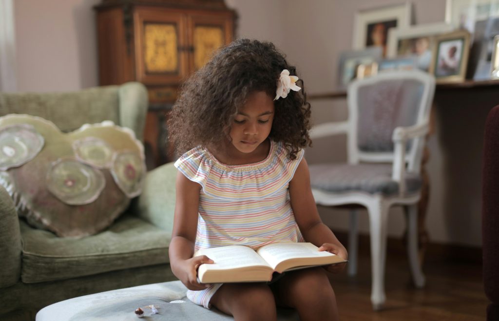 Parent reading a picture book with a child at home