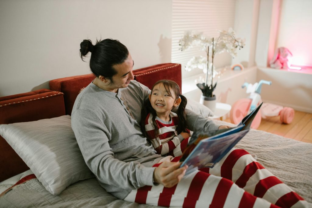 Parent reading a bedtime story in a calm bedroom setting