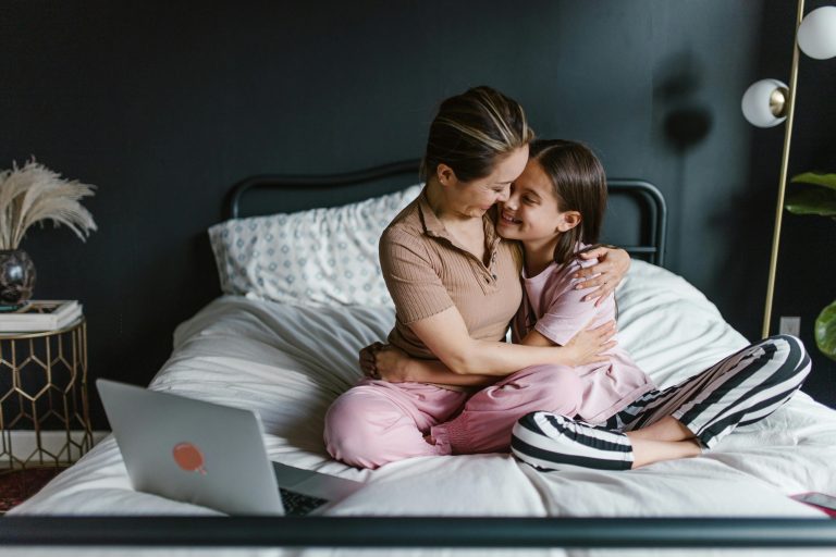 Parent staying calm beside a child during a difficult emotional moment at home