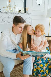 Parents reading with a child during a quiet evening