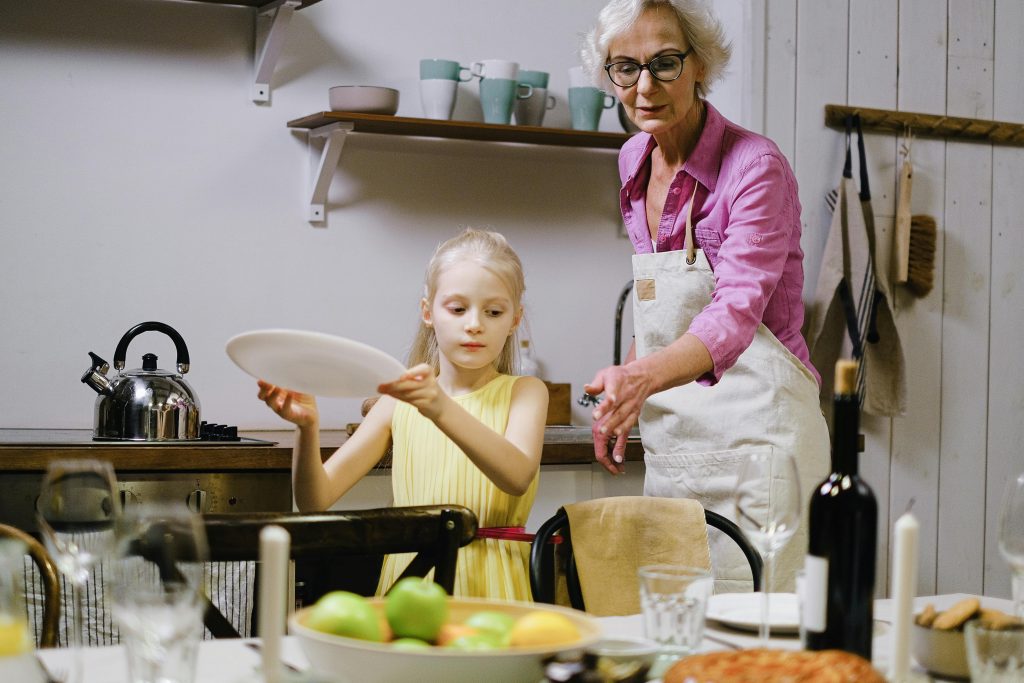 Child helping prepare the dinner table at home