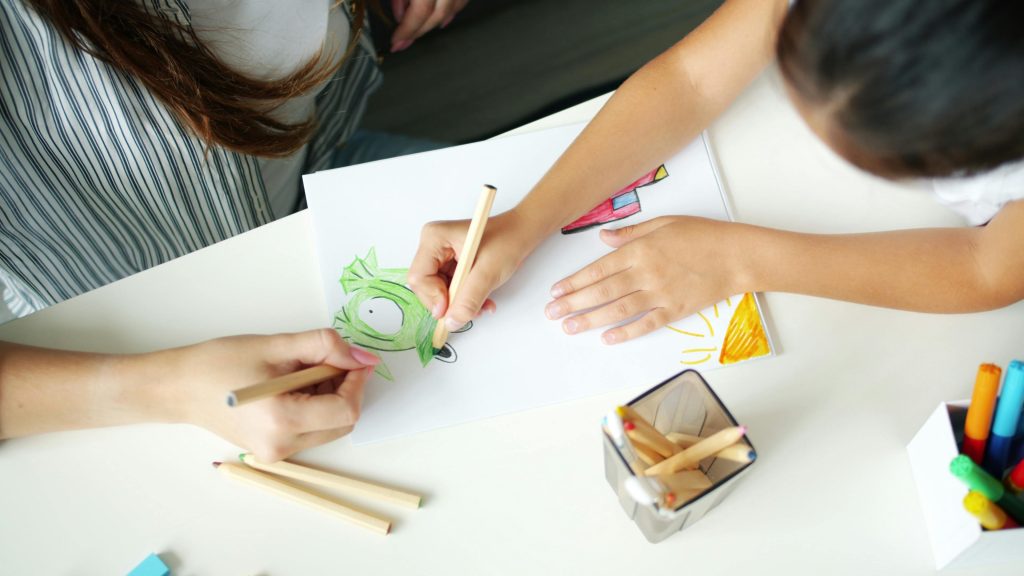 Parent and child discussing a drawing together at home