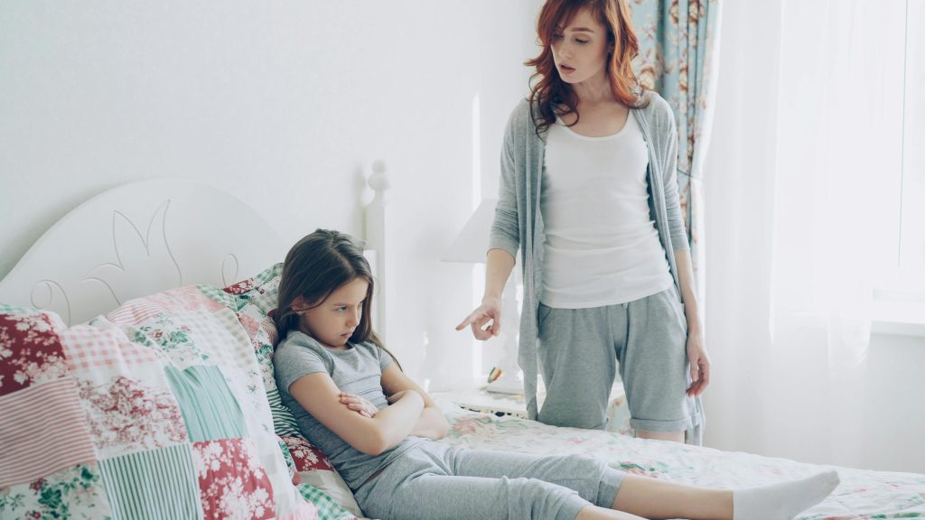 Parent using calm body language to help a child settle after conflict