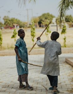 Two children playing creatively outdoors