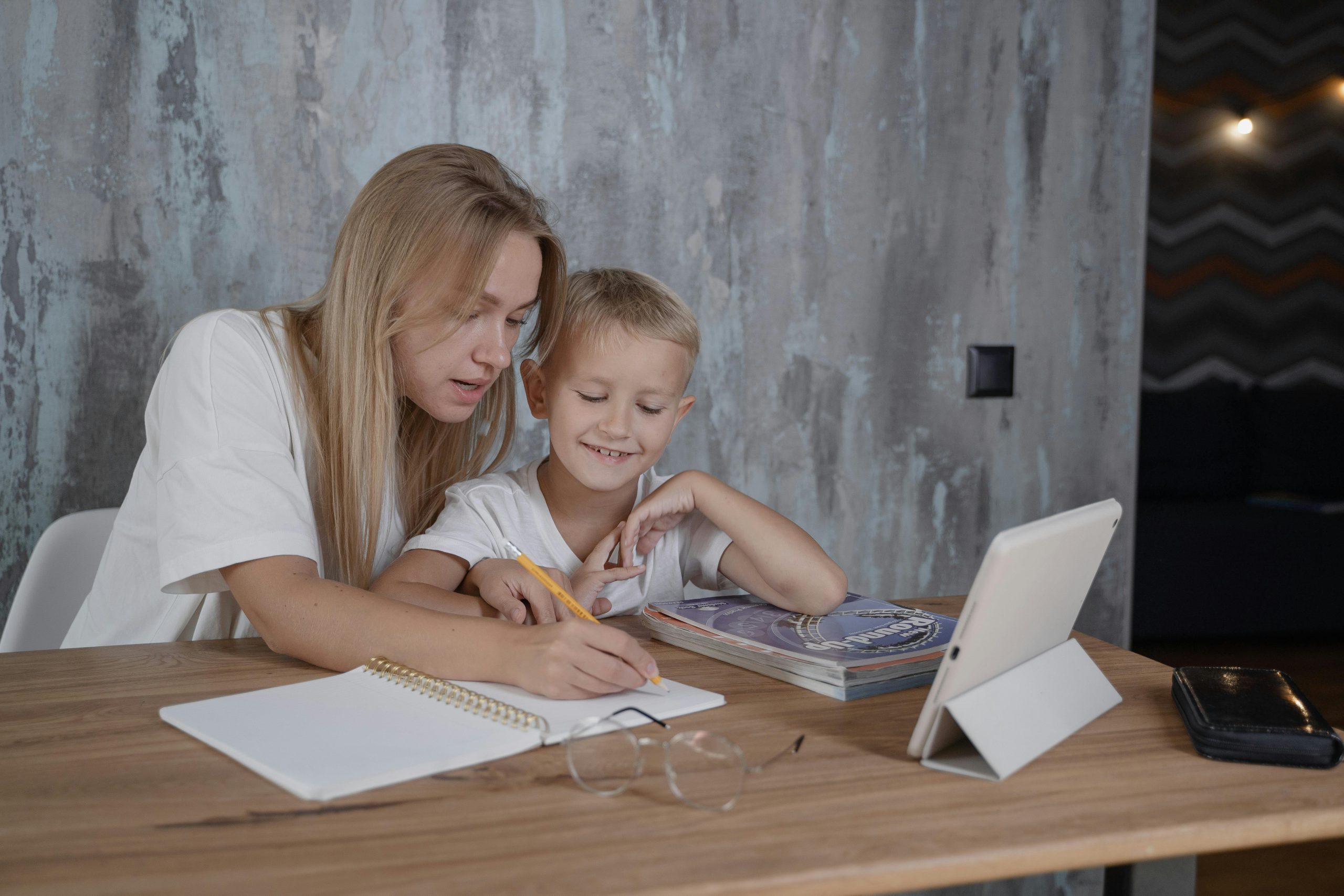 Parent and child doing familiar home practice together at a table