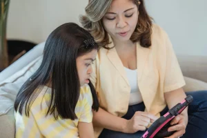 Parent helping a child leave screen time and move into the next family routine