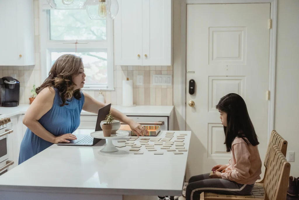Parent listening as a child answers a learning question at home