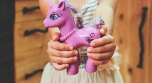 Child holding a favorite belonging closely during play at home