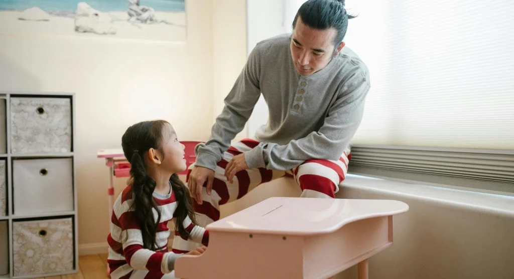 Parent encouraging a child after a successful finish to home practice