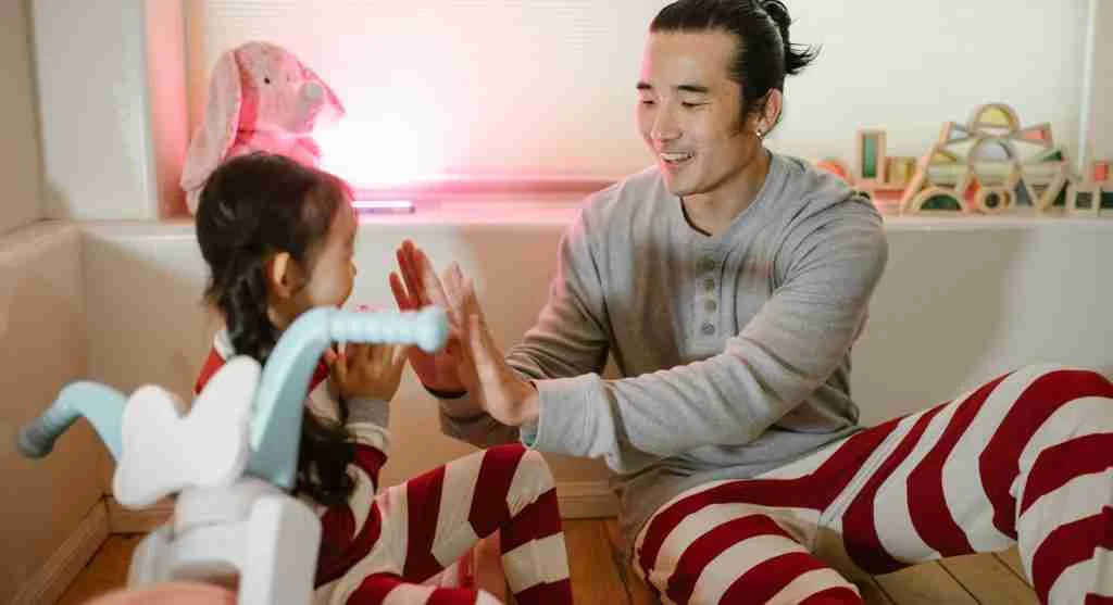 Parent starting a familiar song to begin a repeated family activity