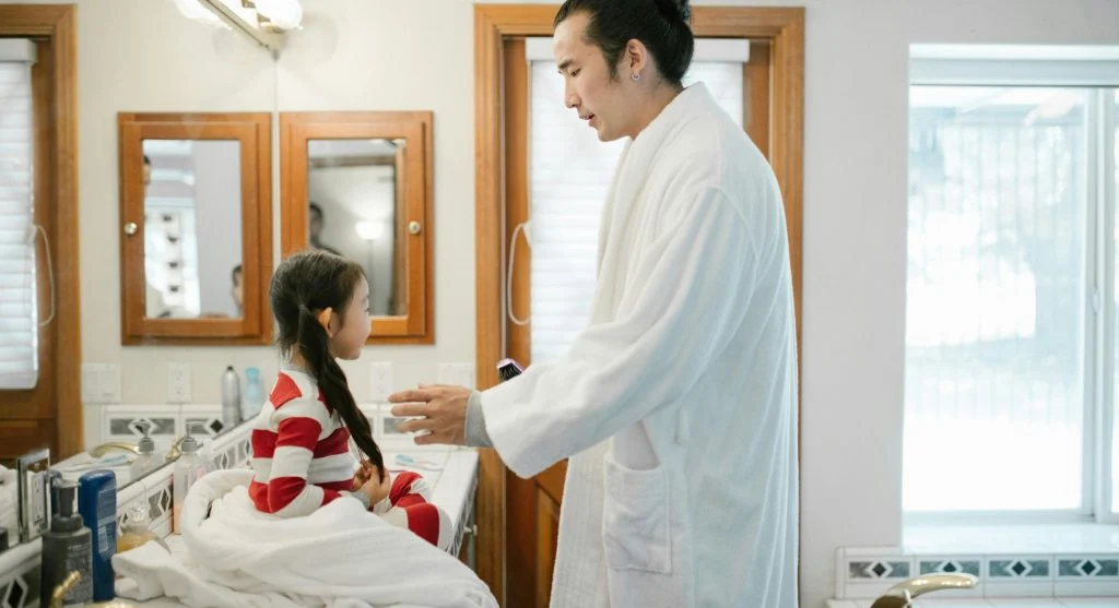 Parent preparing the next routine item before helping a child change activities at home