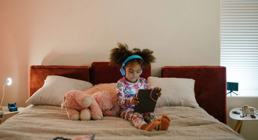 Child returning a tablet to its charger as part of a home routine