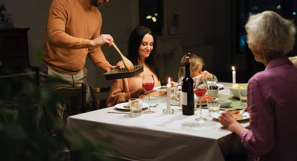 Family sharing a familiar closing phrase at the end of a home ritual