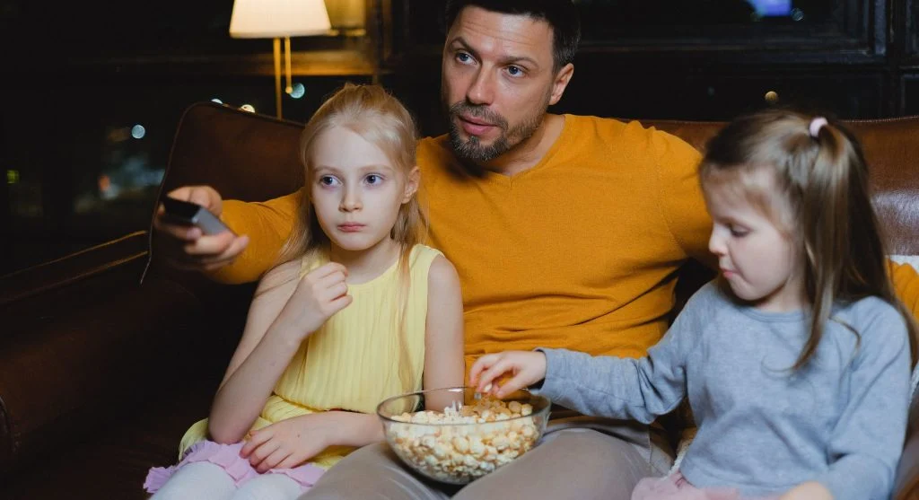 Child watching a scene end before screen time stops at home