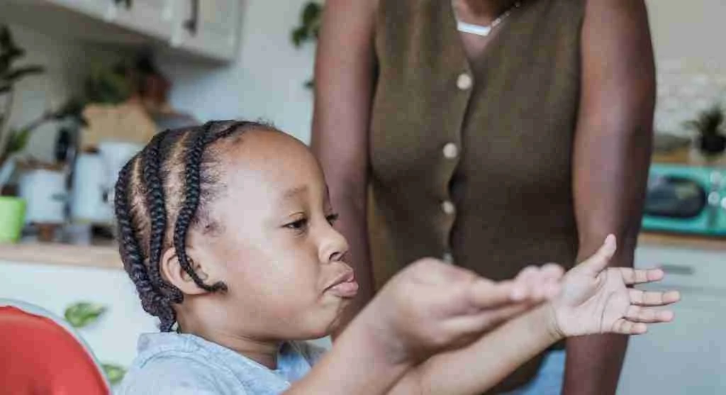 Parent modeling calm during a small awkward moment while a child watches