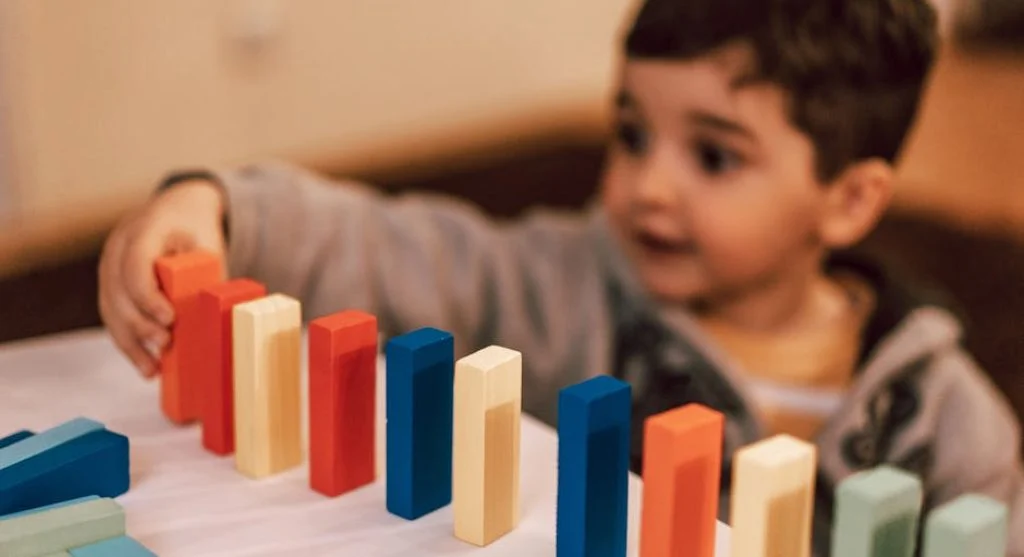 happy child playing with blocks