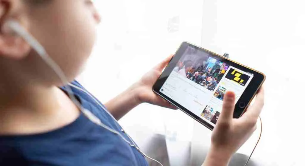 Child watching a video with lowered volume before screen time ends