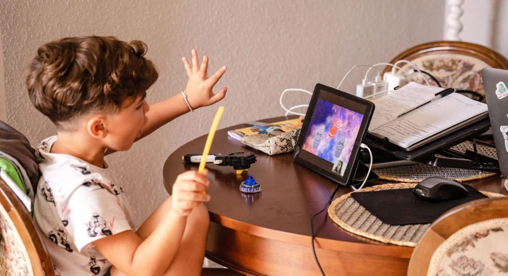Child noticing the charging station light before screen time ends