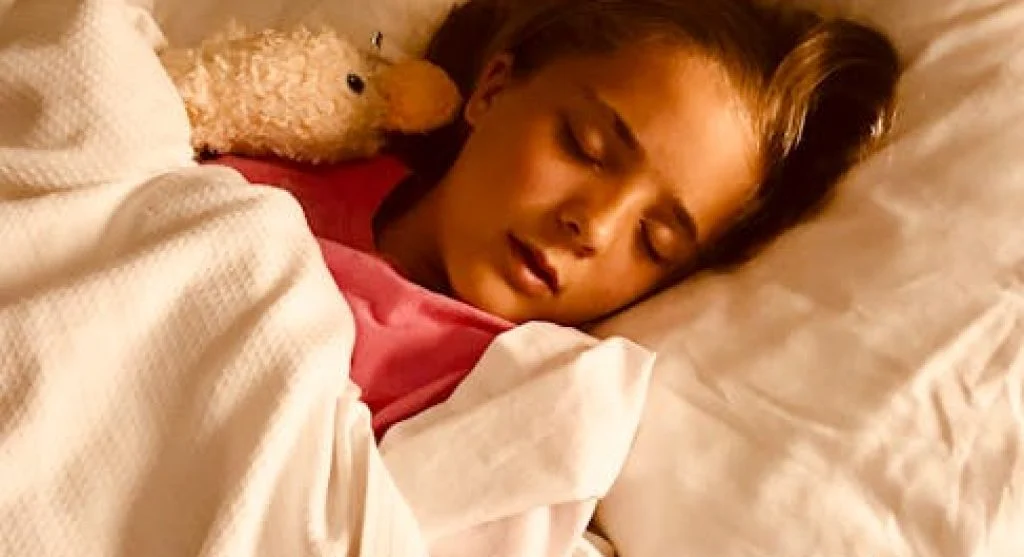 tired kid sleeping in bed