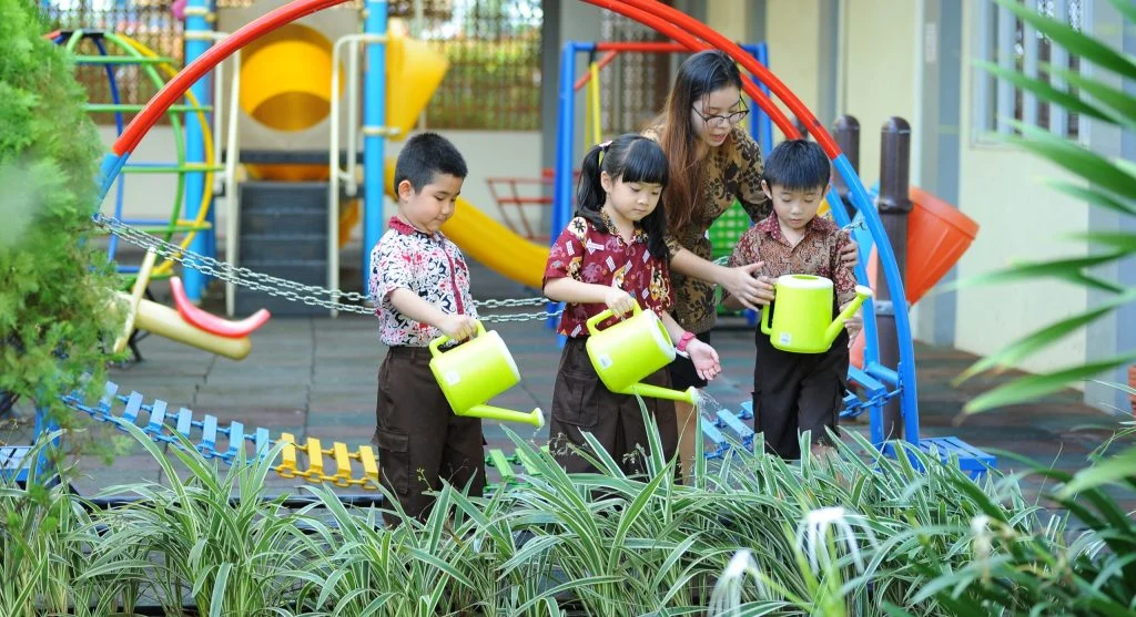 Child showing the first step of a task while a parent watches calmly