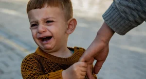 parent comforting child at home