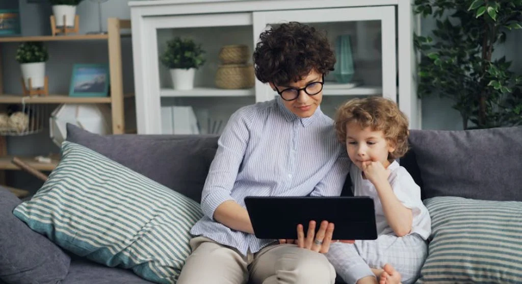 parent and child using tablet together