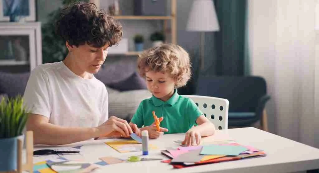 Child comparing two household objects for a school-readiness activity at home